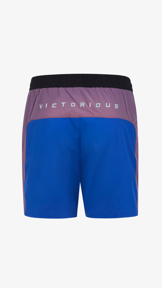 Cassius Short in black, purple, green and blue, back view