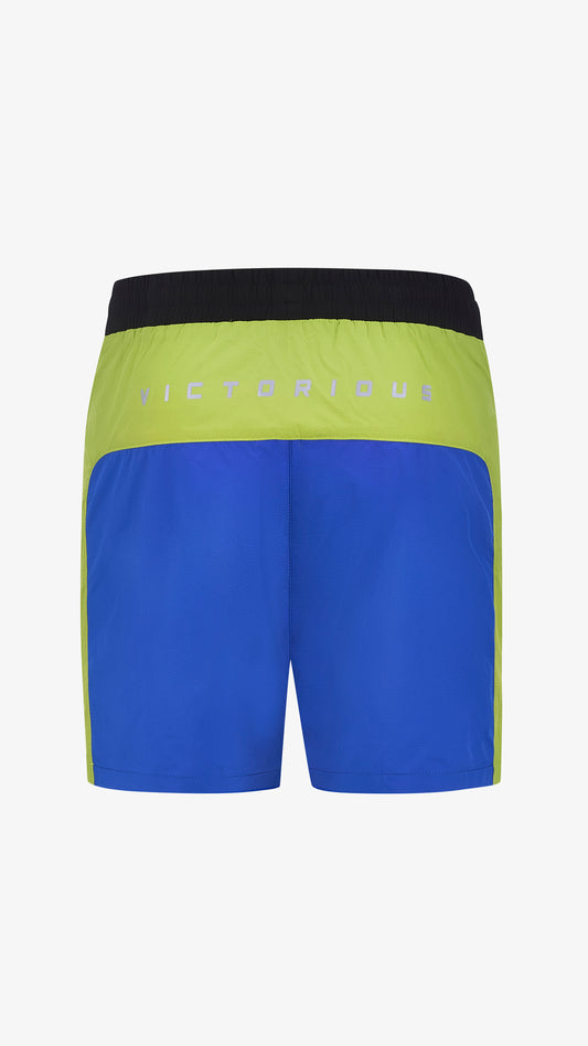 Cassius Short in blue, red, black and green, back view